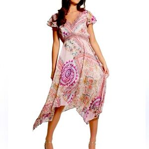 Beautiful asymmetrical dress with fluttery cap sleeves and crochet details. Sz S